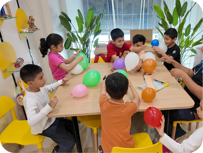 Children inflating balloons in a Robokidz hands-on science workshop
