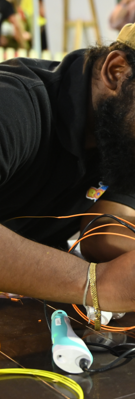 In frames — trainer wiring a build at RPL Finals