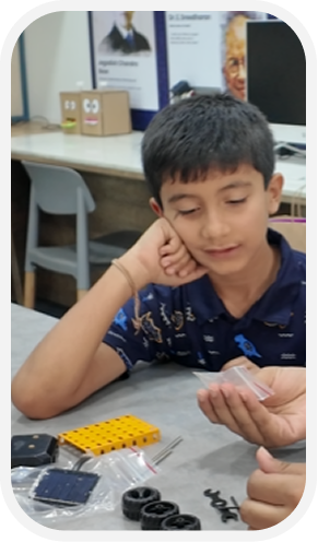 YEA — student with a robotics kit